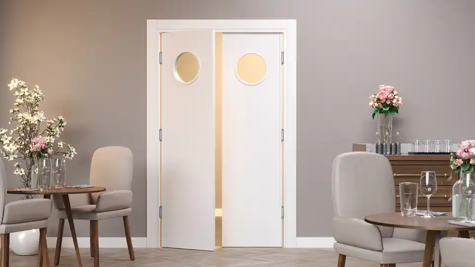 Double-door swing with round portholes in a restaurant dining room